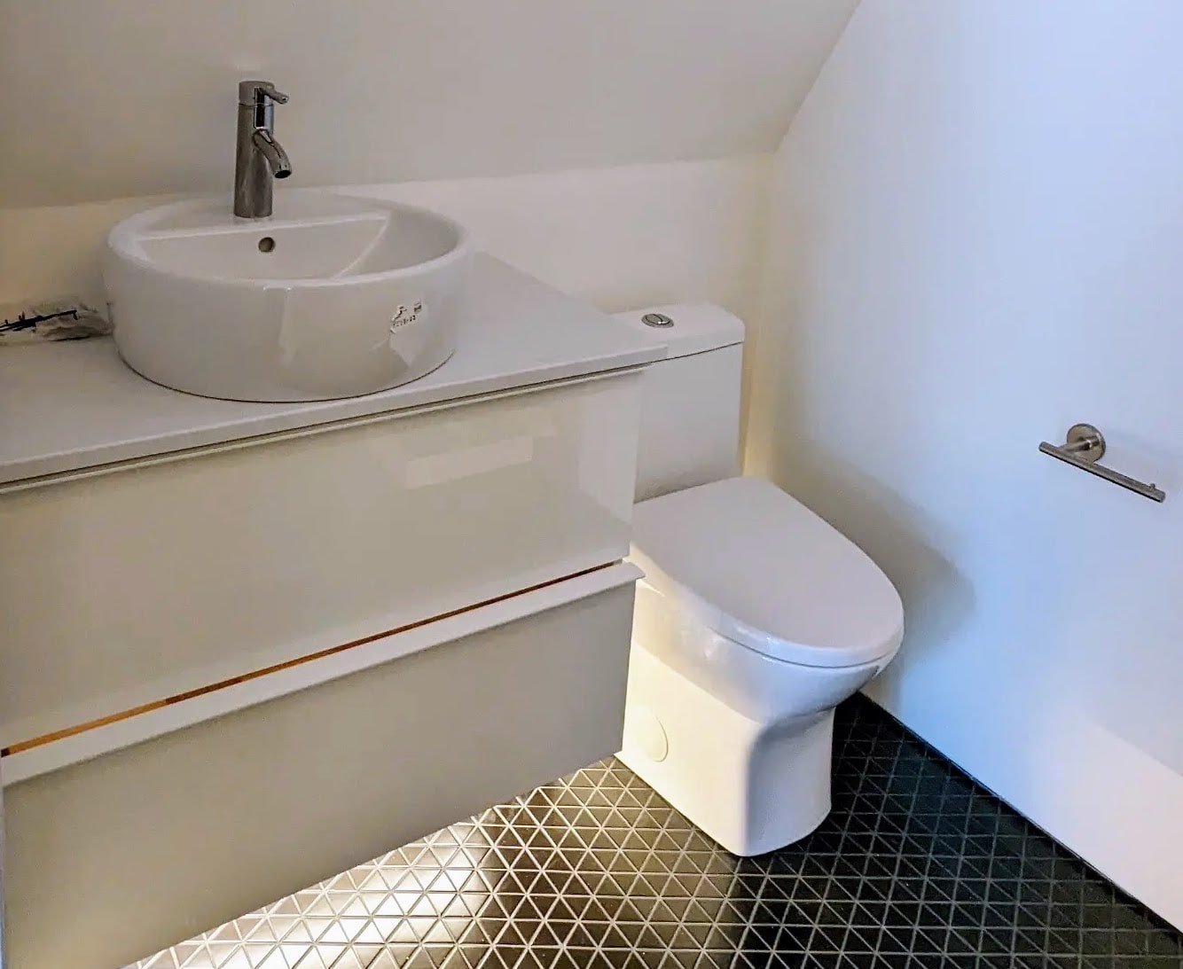 Photo of bathroom vanity and toilet being installed.