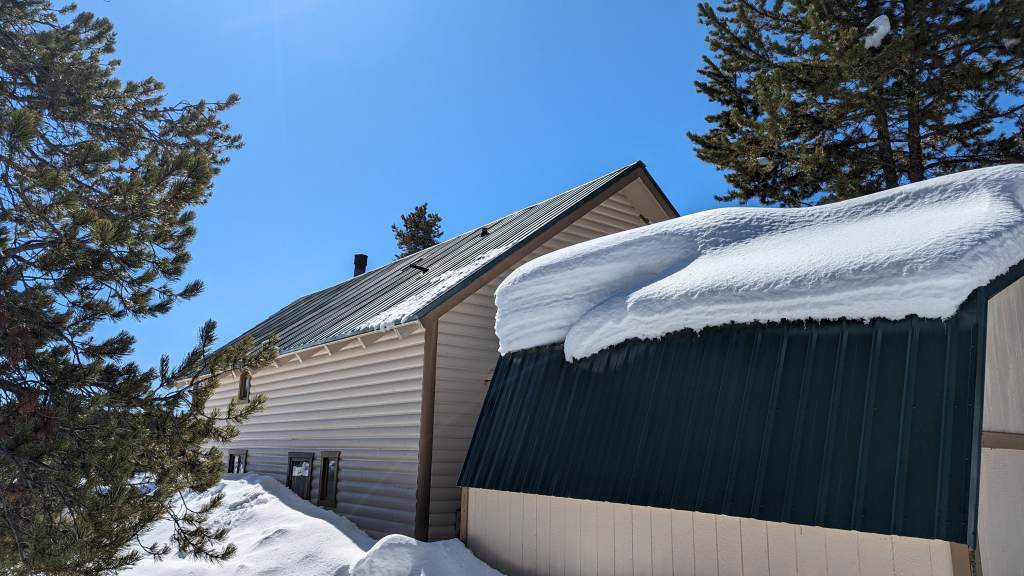 Photo of damaged pipe jacks from avalanching snow is the sign of poor cabin roof design.