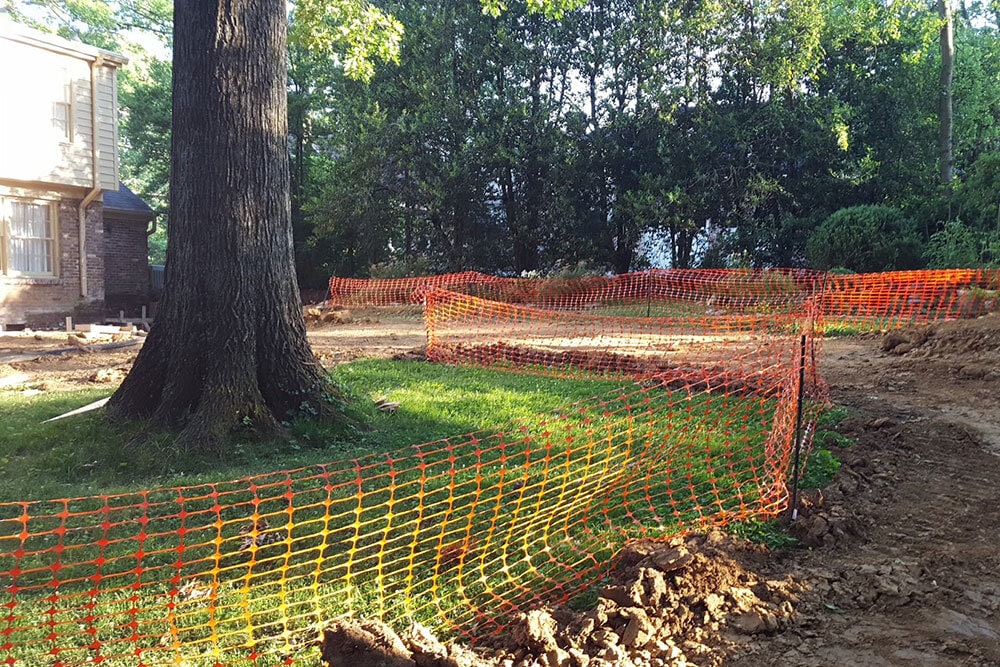 Photo of construction fencing around trees.